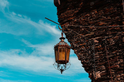 Low angle view of street light against building