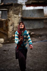 Portrait of young woman standing outdoors