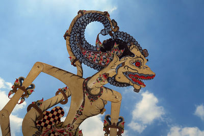 Low angle view of wayang kulit against sky