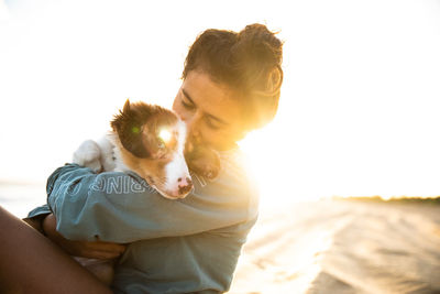 Woman embracing dog outdoors