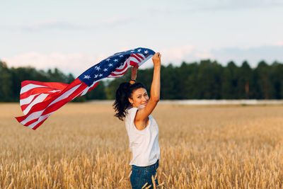 Woman standing on field against sky