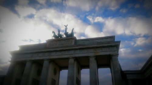 Low angle view of statue against cloudy sky