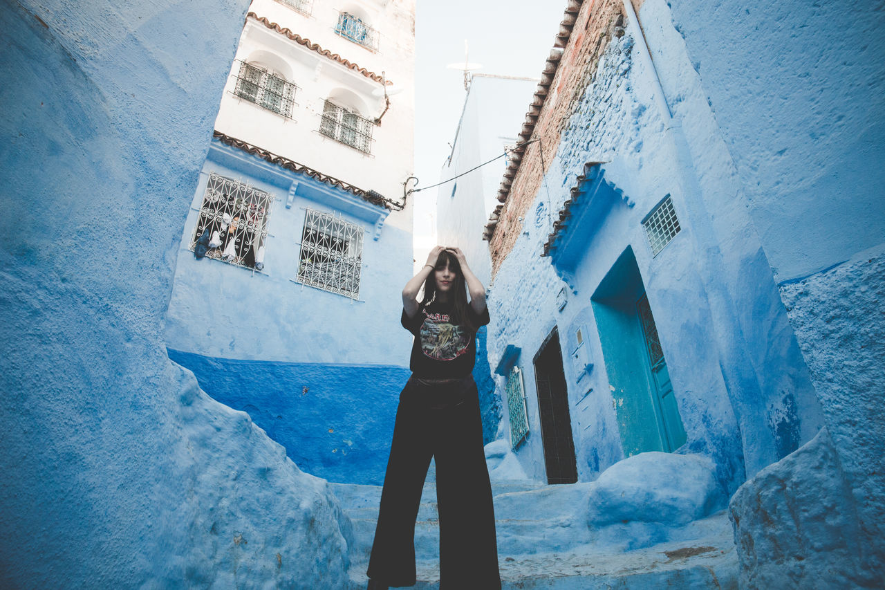 WOMAN STANDING ON A WALL