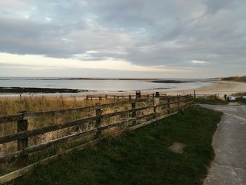 Scenic view of beach against sky during sunset