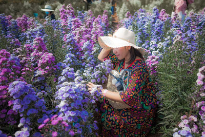 Side view of woman with pink flowers