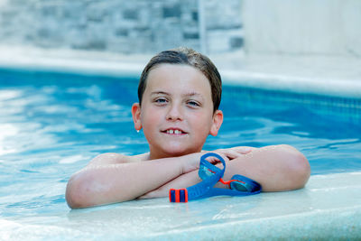 Portrait of boy smiling in swimming pool