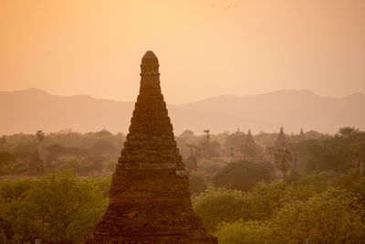 Stupa against clear sky during sunset