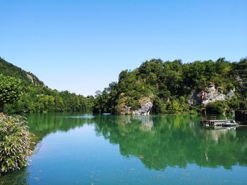 Scenic view of lake against clear blue sky. scenic view of river and mountain against sky