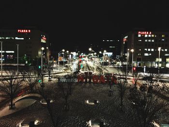 High angle view of illuminated cityscape against sky at night