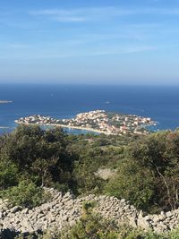 High angle view of townscape by sea against sky