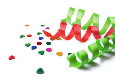 Close-up of multi colored candies against white background