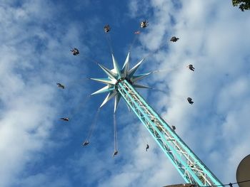 Low angle view of amusement park ride against sky