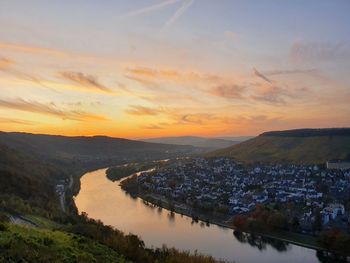 Scenic view of river against sky during sunset