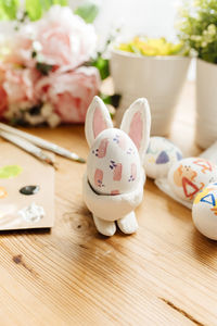 Hand painted easter egg inside a handmade easter bunny egg cup