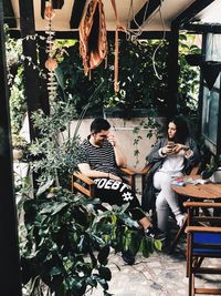 Young couple sitting outdoors