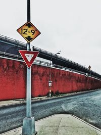 Low angle view of road sign against clear sky