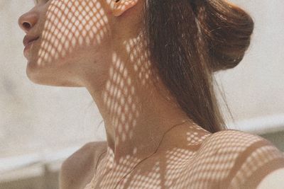 Close-up of shadow on neck of young woman