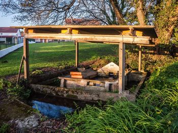 Built structure on field against trees