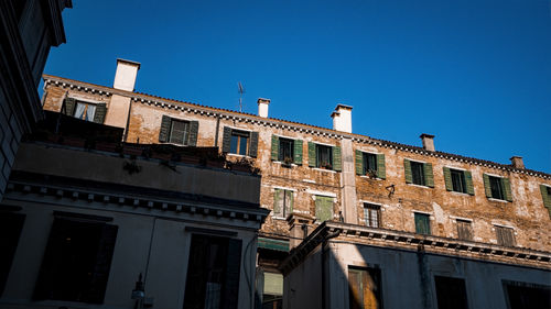 Low angle view of building against clear blue sky