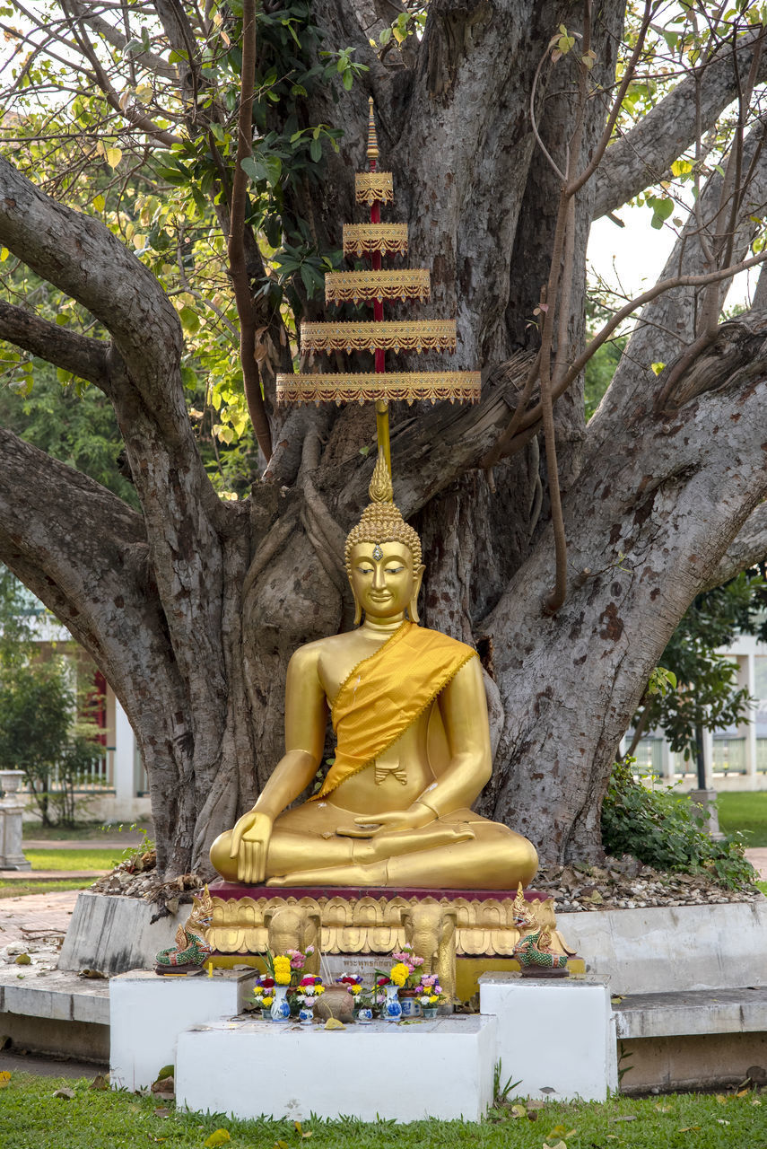 STATUE AGAINST TEMPLE