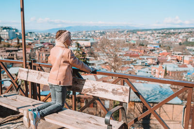 Rear view of woman looking at cityscape