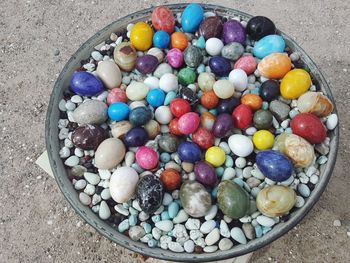 High angle view of multi colored eggs in container