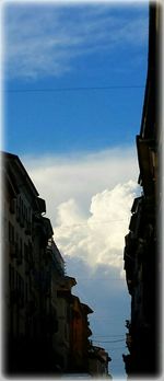 Buildings against cloudy sky