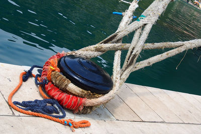 Ropes tied up on bollard at harbor