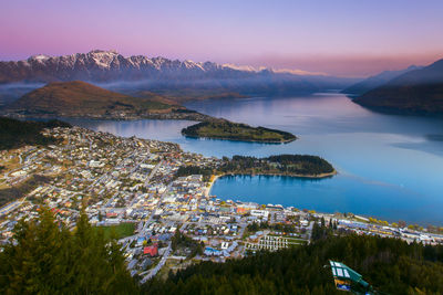 Aerial view of illuminated city at waterfront