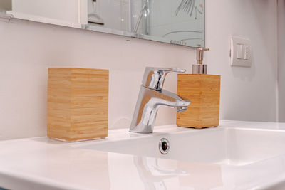 Sink in bathroom with wooden soap dispenser