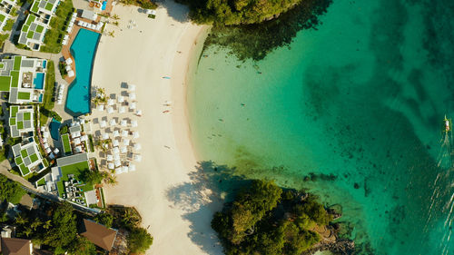 Cove with white beach in blue lagoon with turquoise waters. seascape with beach on tropical island. 