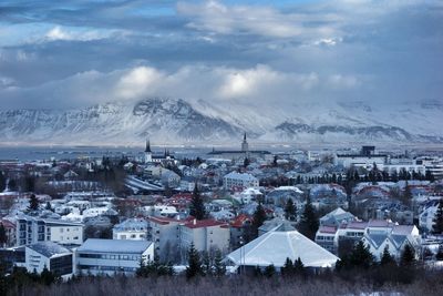 Snow covered mountain against cloudy sky