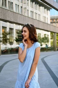 Beautiful young woman on street in city