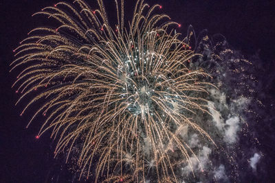 Low angle view of firework display at night