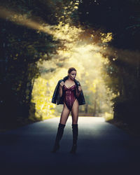 Full length of woman in lingerie standing on road