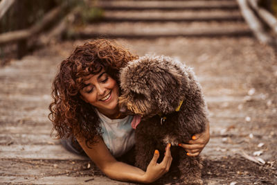 Portrait of young woman sitting on footpath