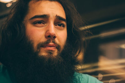 Close-up of bearded thoughtful young man