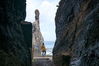 Rear view of woman looking at sea against sky