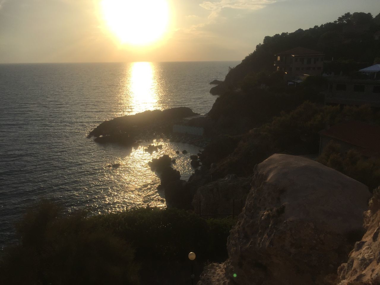 ROCKS ON BEACH AGAINST SKY DURING SUNSET