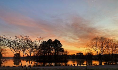 Scenic view of lake against romantic sky at sunset