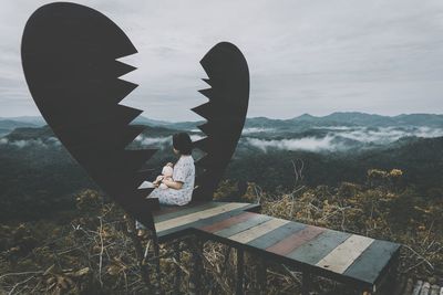 High angle view of man with umbrella on mountain