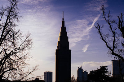 Low angle view of buildings against cloudy sky