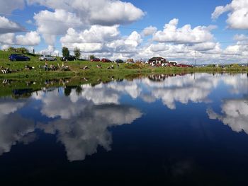 Scenic view of calm lake against cloudy sky