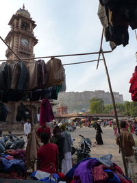 Group of people against sky in city