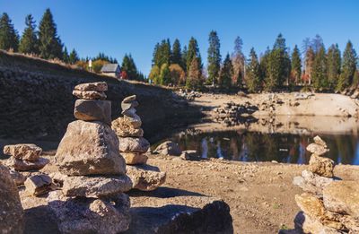 Stack of rocks on shore against sky