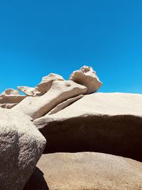 Low angle view of rock formation against blue sky
