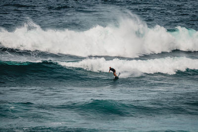 Man surfing waves in atlantic ocean, tenerife, spain