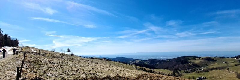 Panoramic view of landscape against blue sky