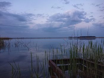 Scenic view of lake against sky at dusk