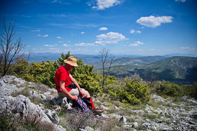 Full length of man standing on mountain against sky